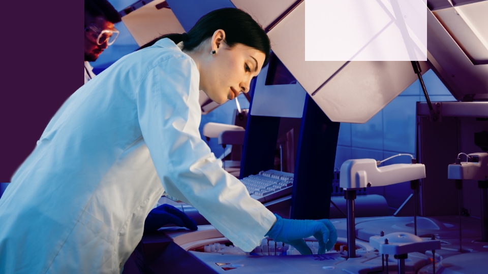A woman examining something at a medical lab with rubber medical gloves.