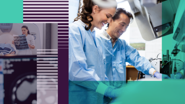 A male and female scientist in a lab standing over a sample.